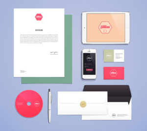 A flat lay of branded stationery and packaging in pastel colors.