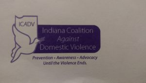 Logo of Indiana Coalition Against Domestic Violence with a purple ribbon.