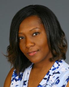 Portrait of a woman with medium-length hair smiling gently.