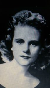 Black-and-white portrait of a woman with curled hair.