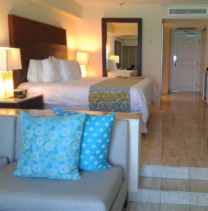 Cozy hotel room with a comfortable bed and stylish seating area.